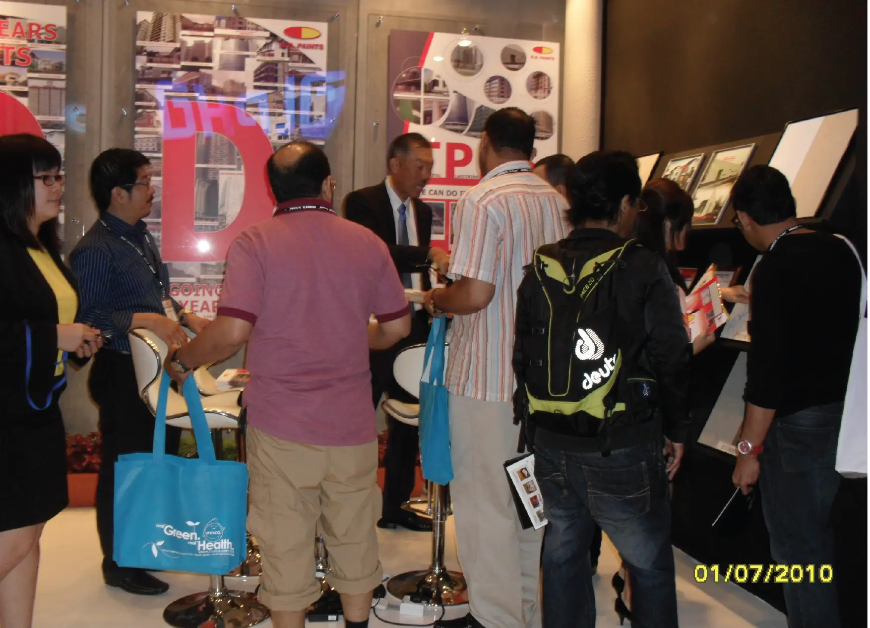 Industry visitors engaging with the O.D. Paints team during an ARCHIDEX exhibition